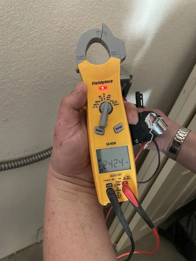 Voltage testing with clamp meter during Whole House Surge Protector in Oxon Hill